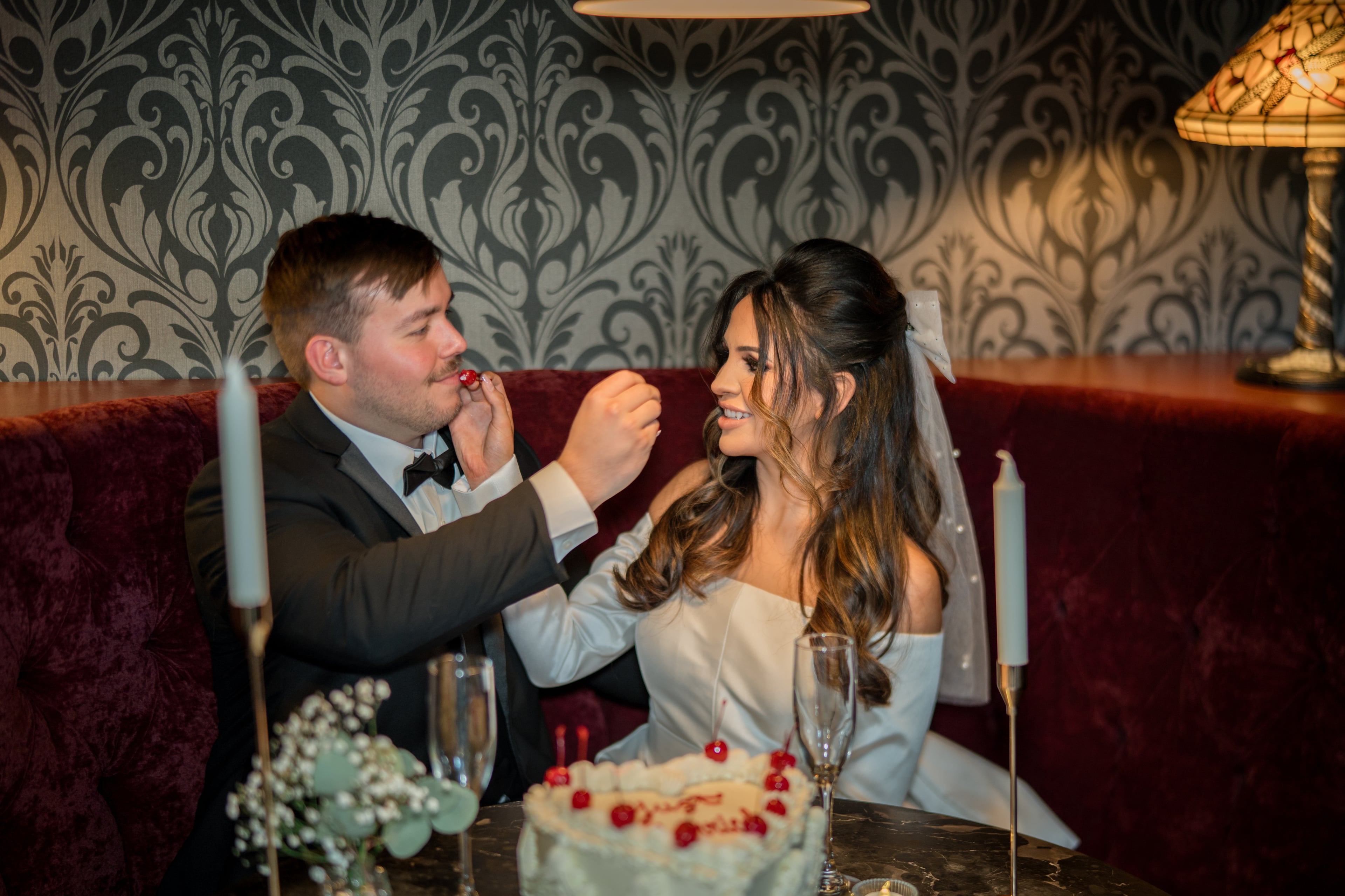 Devils River Vintage Wedding Cake Couple feeding each other vintage wedding cake